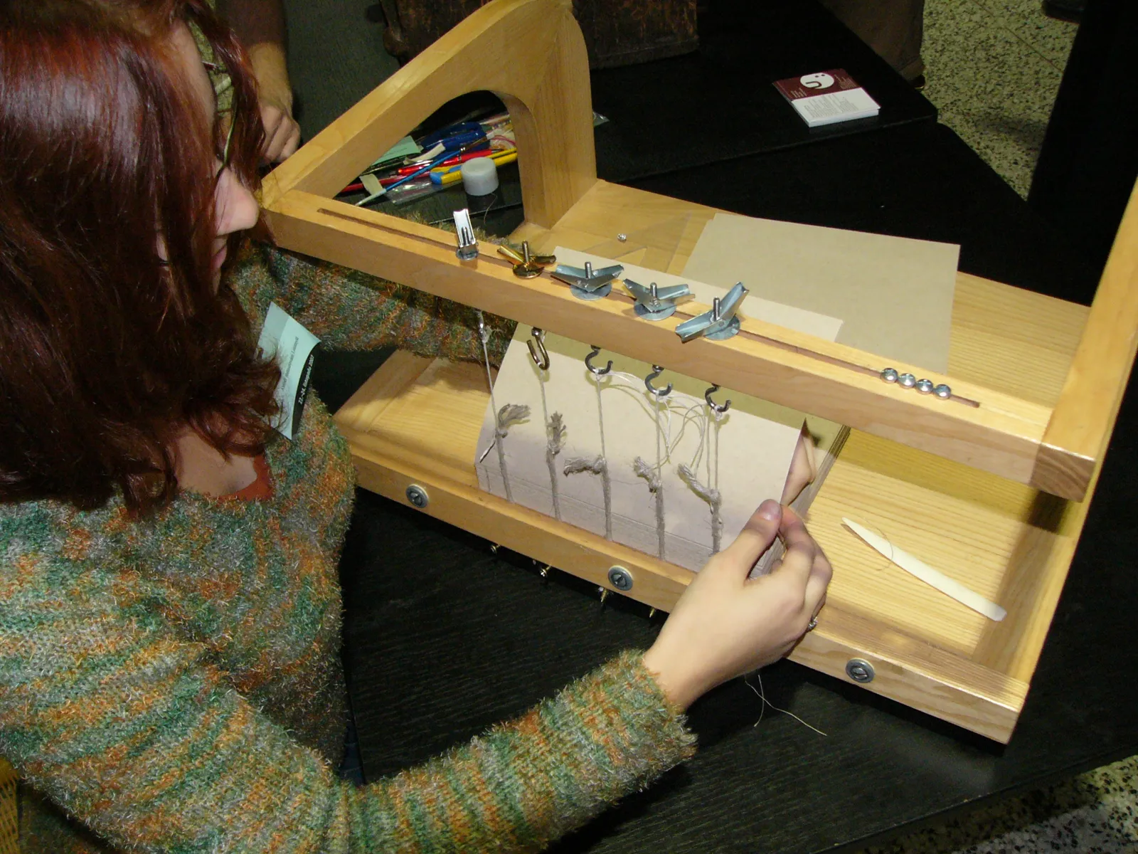 Hand bookbinding on a sewing frame